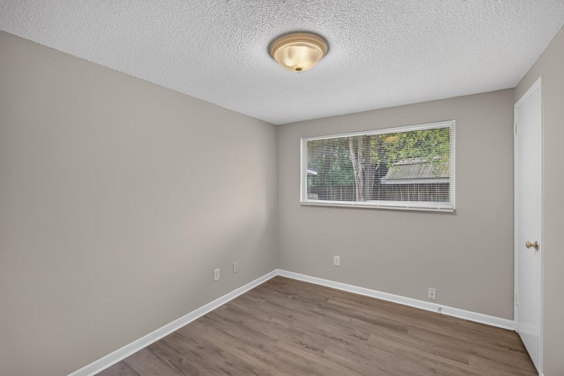 Bedroom with window and wood-look flooring at 1435 Undine Ave, Jacksonville, FL