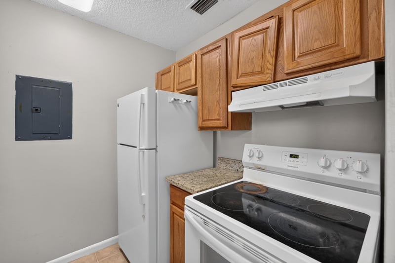 Kitchen with white appliances and wood cabinets at 2719 Trollie Ln
