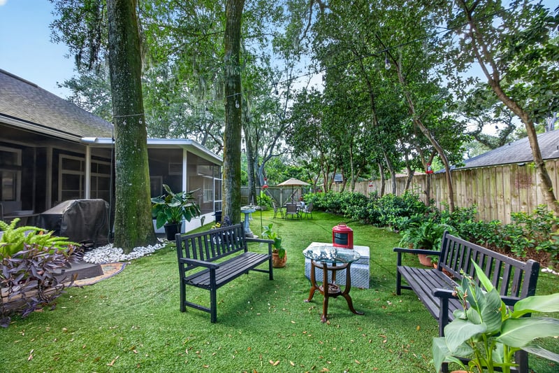 Backyard seating area with bench and garden beds at 1346 Gately Ct, Jacksonville, FL 32225