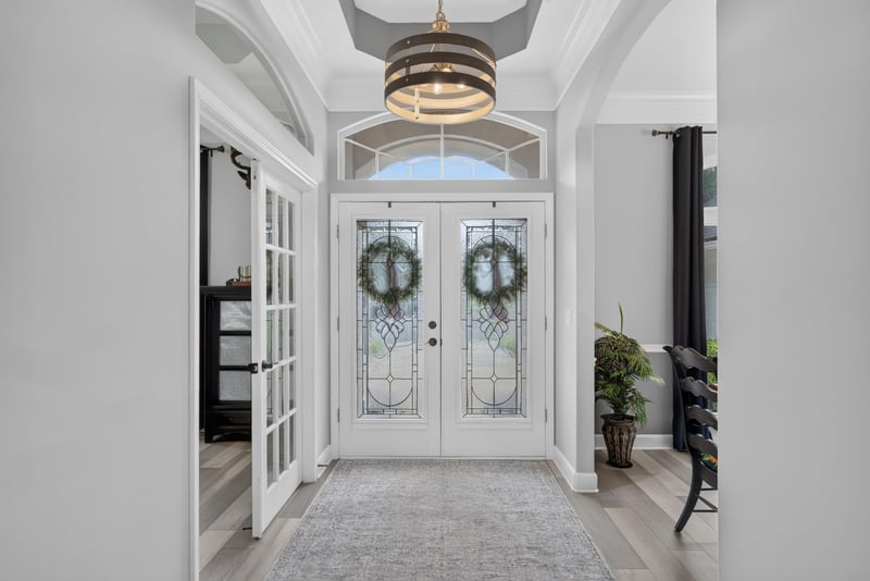 Foyer with double entry doors and chandelier at 2304 Spring Hill Ct, Orange Park, FL