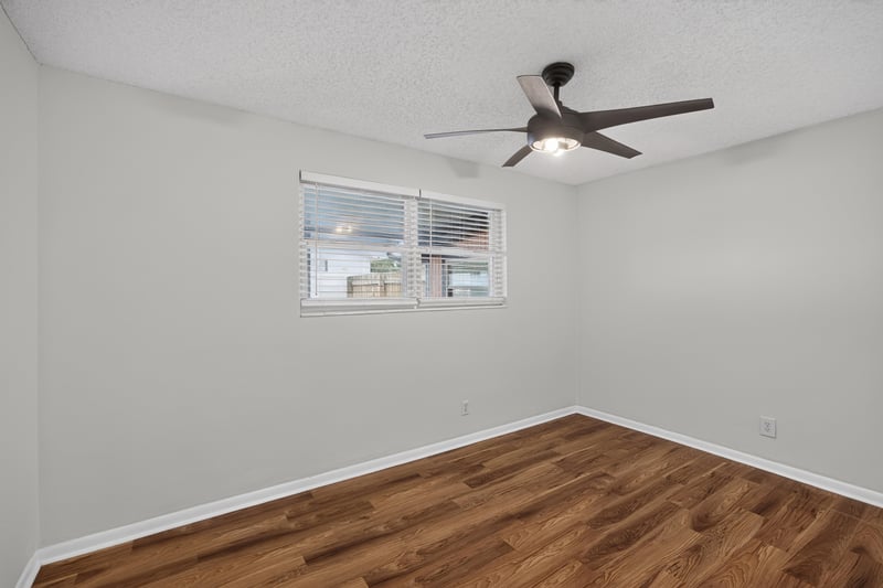 Bedroom with window, wood floor and ceiling fan at 4039 Habana Ave, Jacksonville, FL