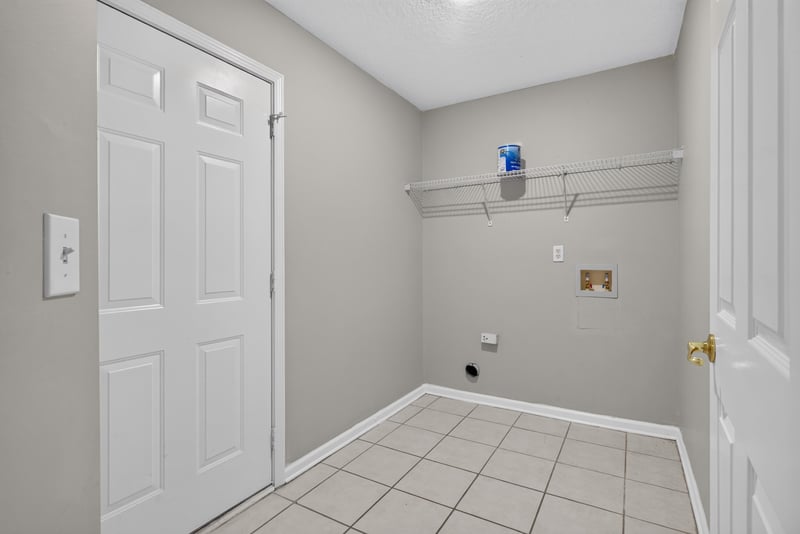 Hallway with laundry closet door at 11669 Collins Creek Dr, Jacksonville, FL 32258