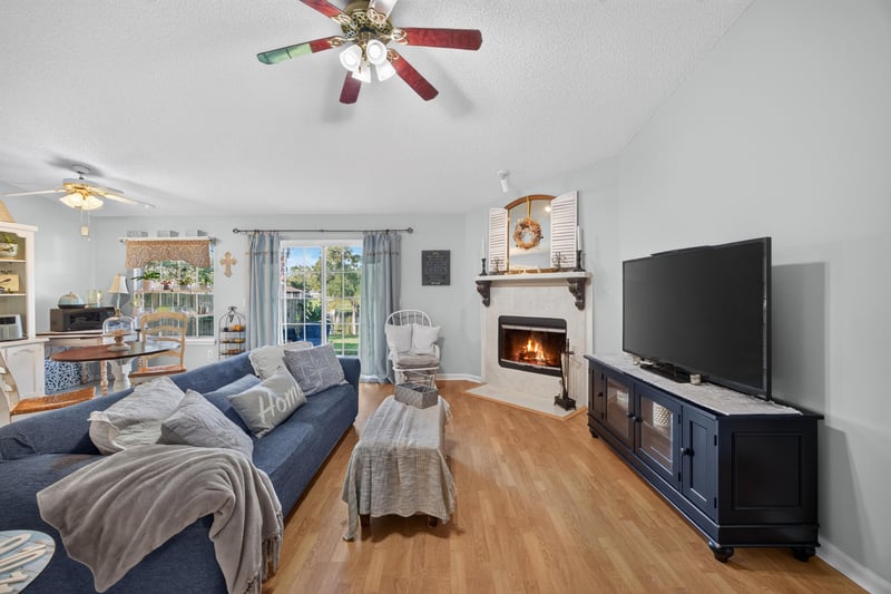 Living room with TV above fireplace at 4556 Shaky Leaf Ln N, Jacksonville, FL 32224
