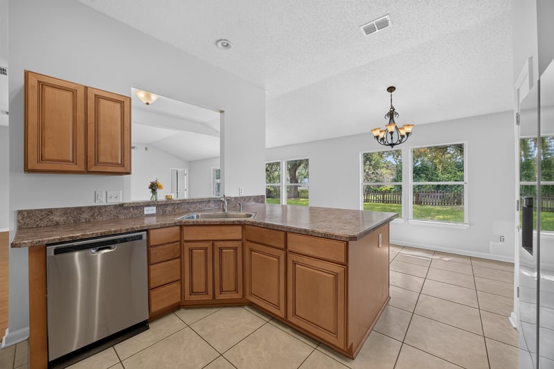 Kitchen with dishwasher and tile backsplash at 456 Bay Point Way N, Jacksonville, FL 32259