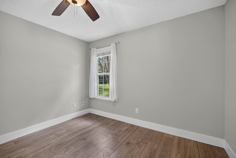 Empty bedroom corner with window at 1161 Whispering Pines Rd, Jacksonville, FL 32259