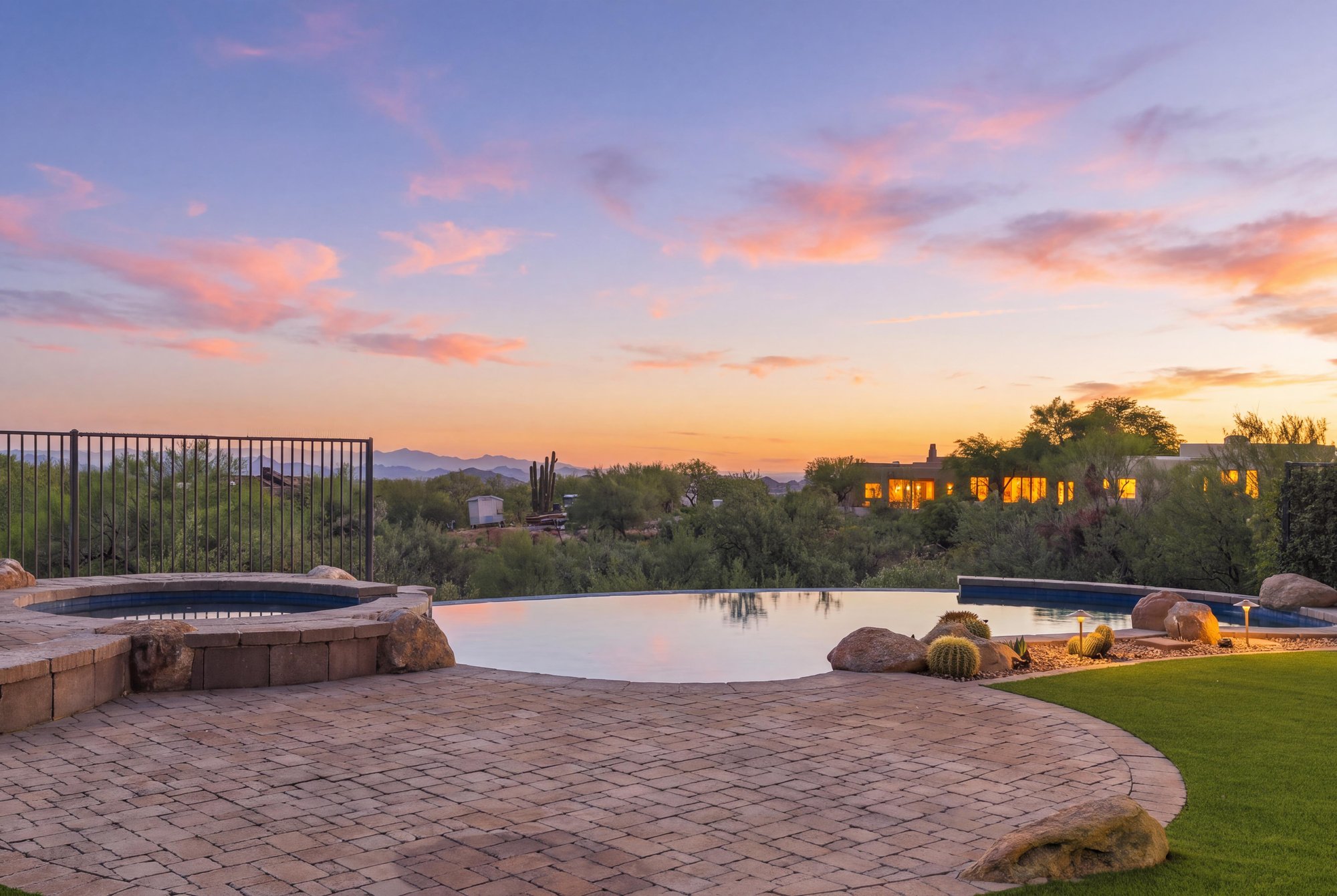 Virtual twilight of an infinity-edge pool and spa looking over the desert