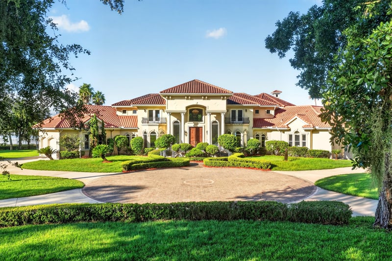 Front exterior with tile roof and circular paver driveway at 344 Broward Rd, Jacksonville, FL