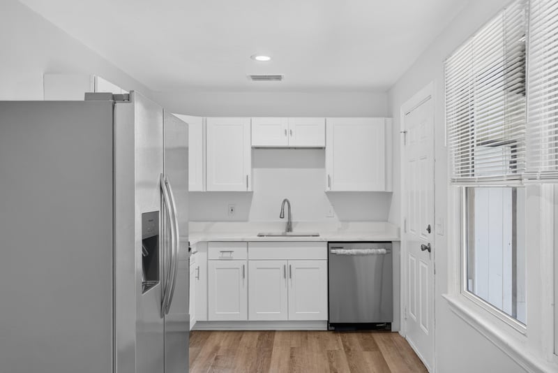 Kitchen with white cabinets and stainless refrigerator at 855 Cornwallis Dr, Jacksonville, FL