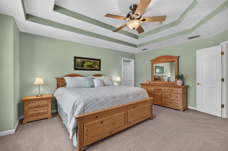 Primary bedroom with wood bedroom furniture at 3660 Middlebrook Dr, Orange Park, FL 32065