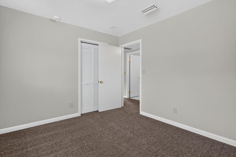 Carpeted hallway with doors at 2618 Arlex Dr E, Jacksonville, FL