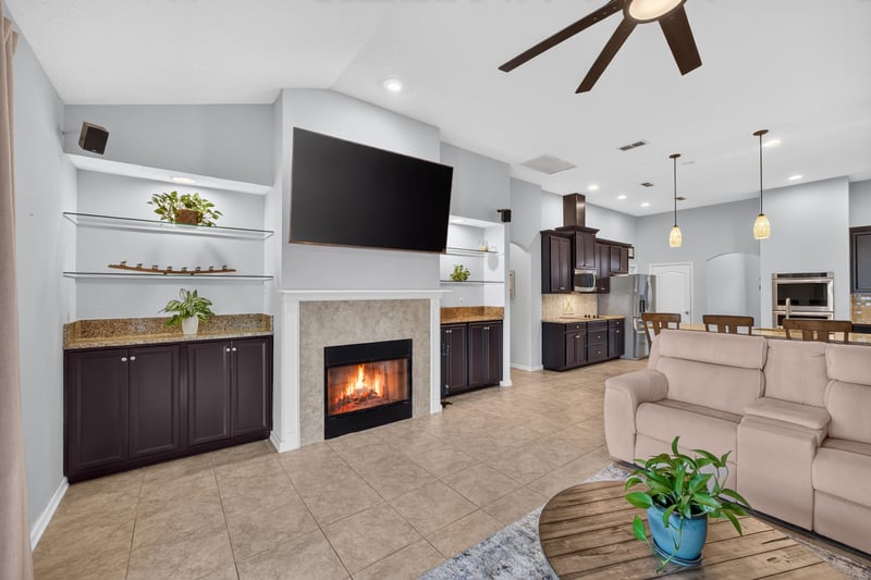Living room with fireplace and built-in shelving at 538 Porta Rosa Circle, St. Augustine, FL 32092