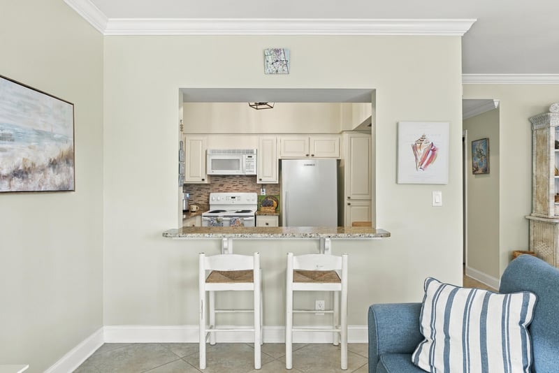 Kitchen pass-through with bar seating at 805 Spinnakers Reach Dr, Ponte Vedra Beach, FL 32082