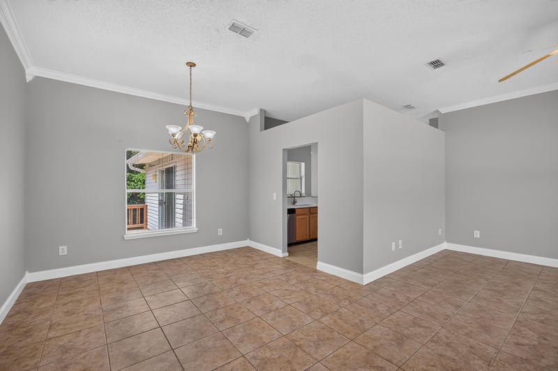 Dining area with tile floor and chandelier at 9256 Dale View Ln W, Jacksonville, FL 32225