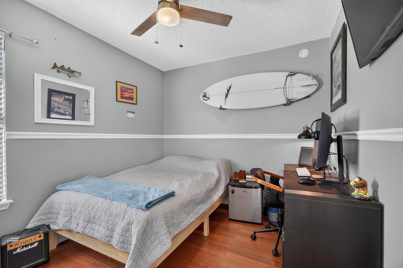 Bedroom with desk and surfboard decor at 4556 Shaky Leaf Ln N, Jacksonville, FL 32224