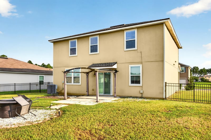 Backyard view with fenced lawn at 6830 Hanford St, Jacksonville, FL 32219
