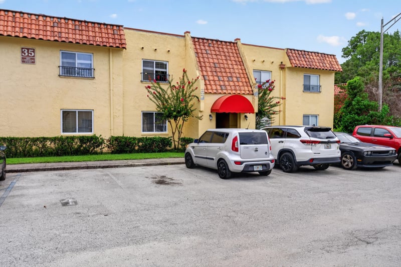 Front exterior with red awnings and parked cars at 3866 Campenero Ct unit 6, Jacksonville, FL 32217