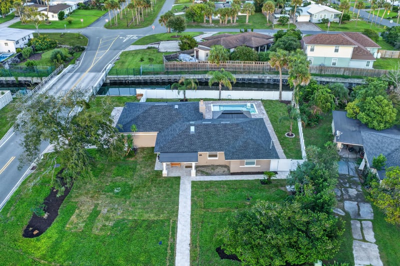 Aerial view of the home and canal-front street at 1525 8th St N, Jacksonville Beach, FL