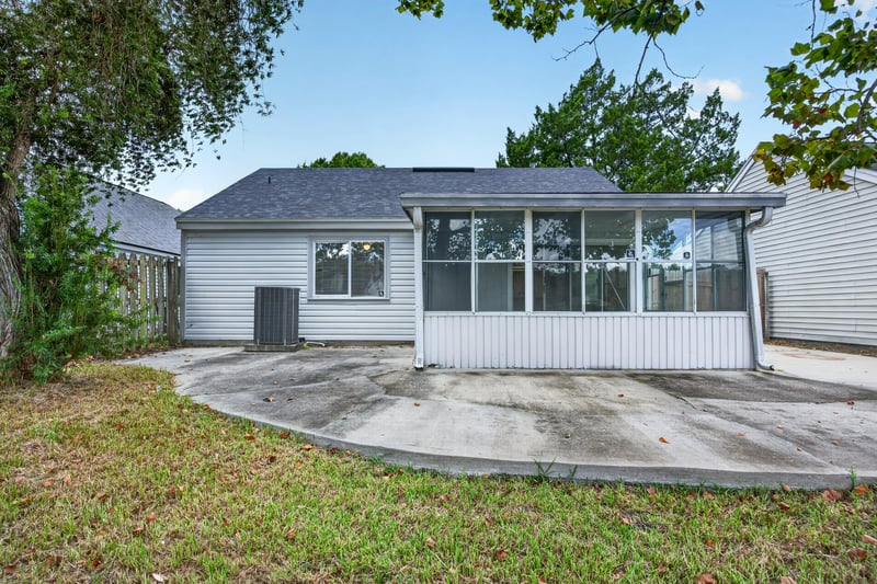 Rear exterior view of sunroom and patio at 8047 Mactavish Way E, Jacksonville, FL 32244