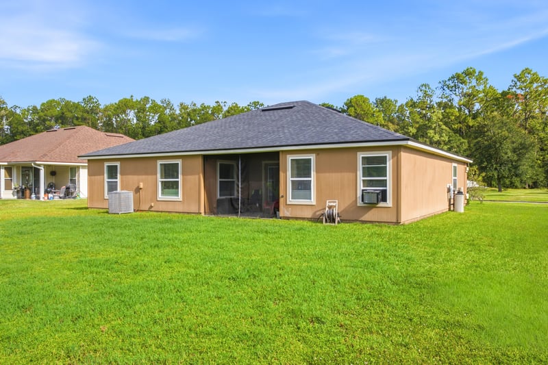 Aerial view of roofline and pond at 7392 Timber Falls Ct