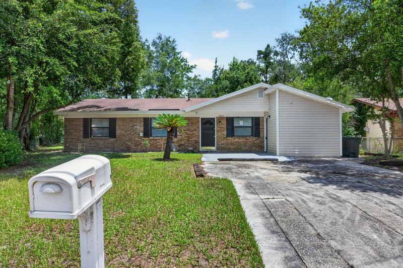Front yard view with mailbox and driveway at 7453 Jade Dr N, Jacksonville, FL 32210