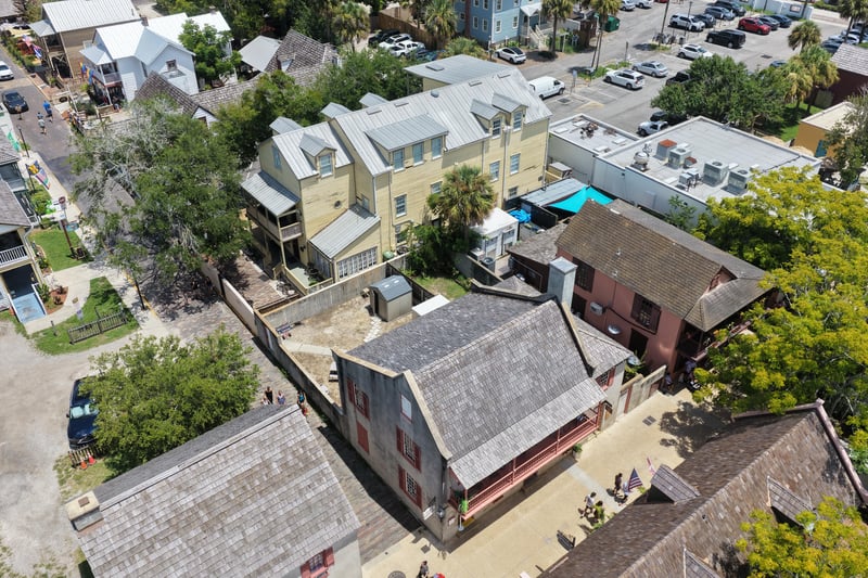 Aerial view of the yellow building roofs and courtyard pool at 29 Cuna St, St. Augustine, FL 32084
