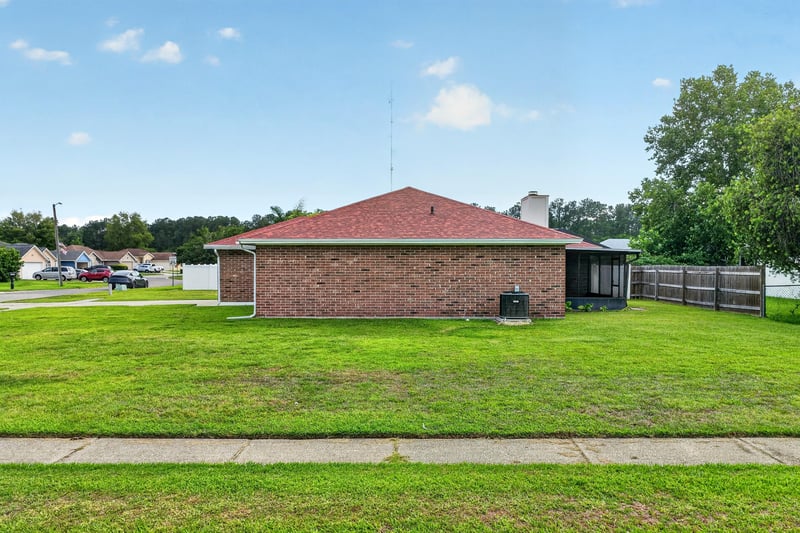 Backyard exterior with grass and chimney at 2164 Orangewood St, Middleburg, FL 32068