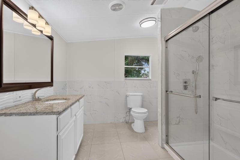Bathroom with vanity, toilet and glass shower at 4565 Appleton Ave, Jacksonville, FL