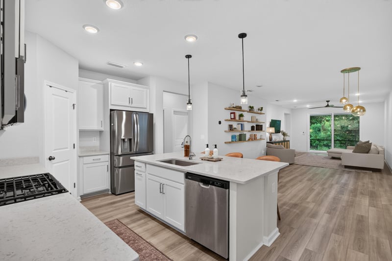 Kitchen with island, pendant lights and stainless fridge at 93 Lochloosa Ct, St. Johns, FL 32259