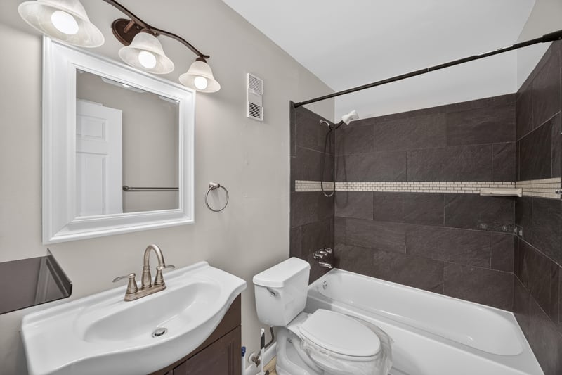 Bathroom with tub, shower, and tiled surround at 700 W Pope Rd unit h61, St. Augustine, FL 32080