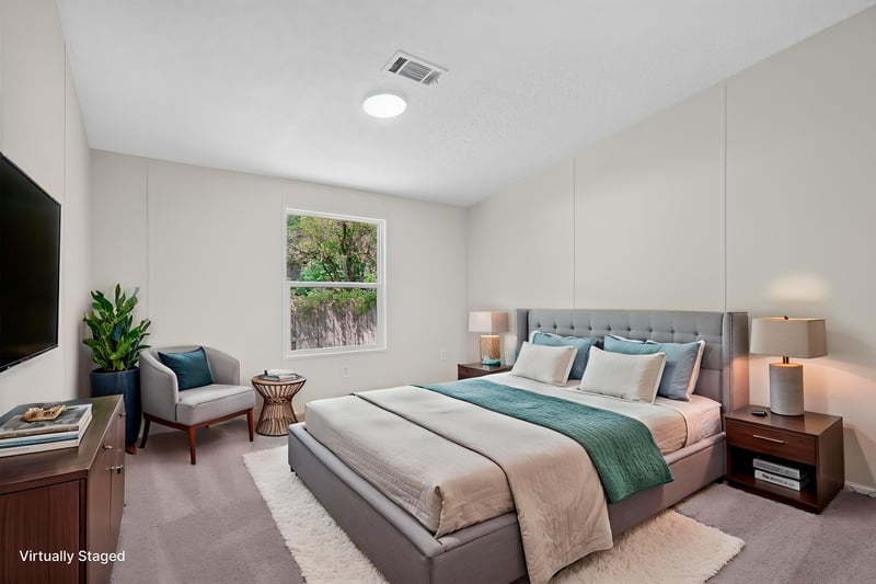 Bedroom staged with bed, nightstands and TV at 7603 Coach Park Dr, Jacksonville, FL 32244