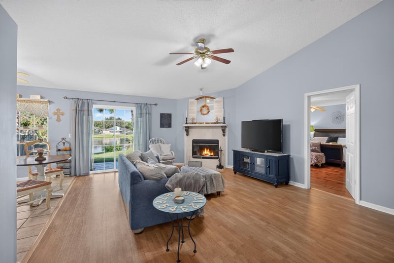 Living room with brick fireplace and blue sofa at 4556 Shaky Leaf Ln N, Jacksonville, FL 32224