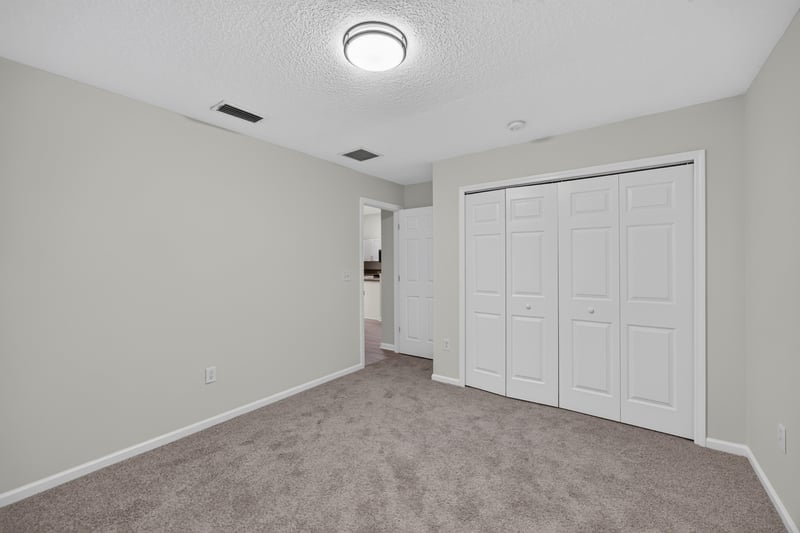 Hallway with closet doors and carpet at 706 Bonaparte Dr, Jacksonville, FL 32218