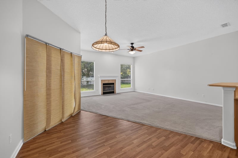 Living room with folding room divider and carpet at 2480 Ridge Will Dr, Jacksonville, FL 32246