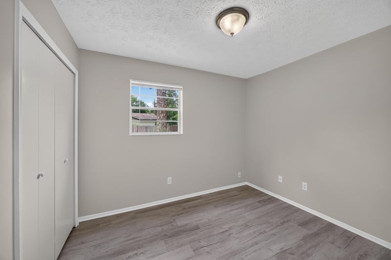Empty bedroom with window and wood-look flooring at 1083 Stokes St, Jacksonville, FL