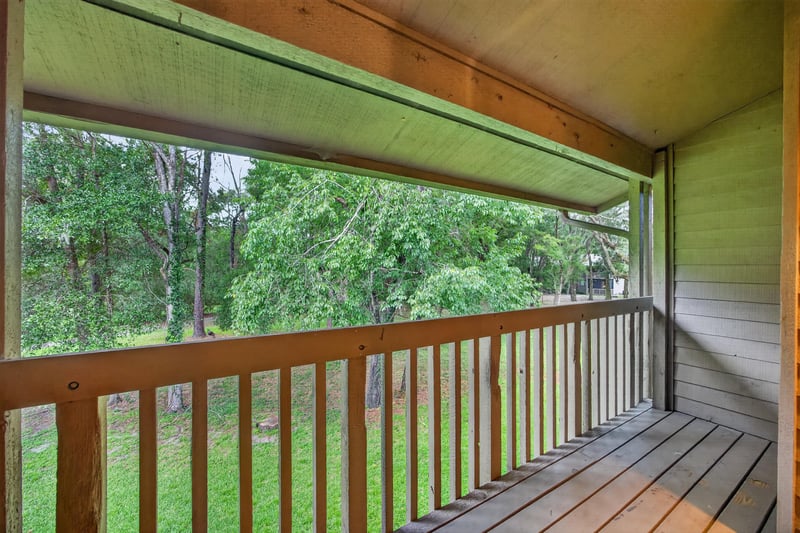Covered balcony overlooking trees at 2910 Ravines Rd, Middleburg, FL 32068