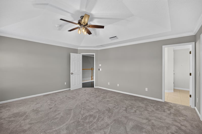 Primary bedroom with carpet and ceiling fan at 1493 Greyfield Dr, St. Augustine, FL 32092