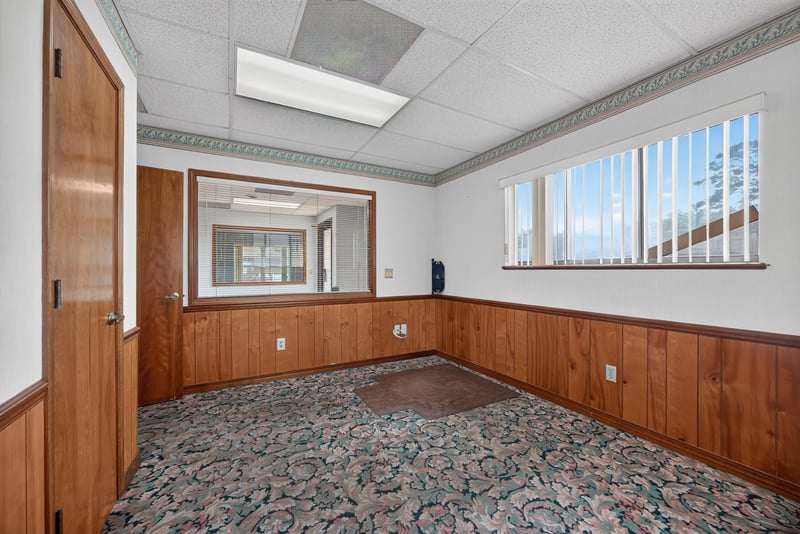 Room with built-in counter under window and floral carpet at 1543 Kingsley Ave #19, Orange Park, FL 32073