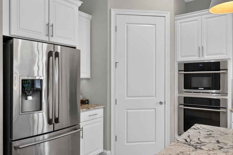 Kitchen stainless refrigerator and pantry door at 3328 Southern Oaks Dr, Green Cove Springs, FL 32043