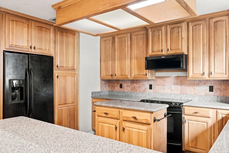 Kitchen with black appliances and granite counters at 2915 Trenton Ct, Orange Park, FL