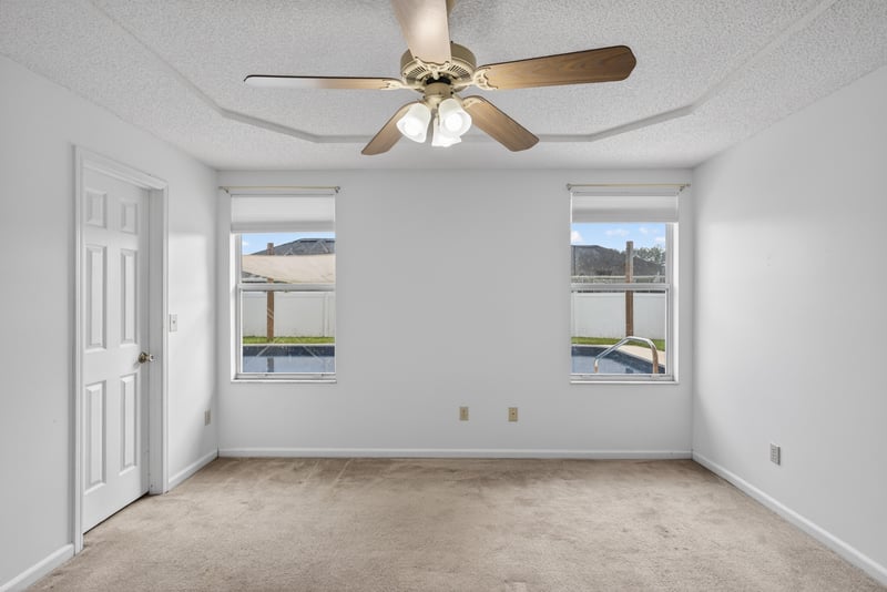 Bedroom with ceiling fan and carpet at 2164 Orangewood St, Middleburg, FL 32068