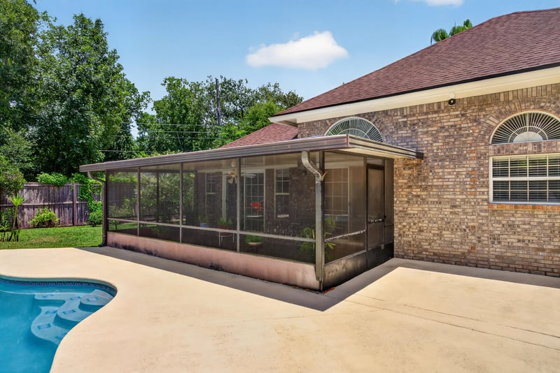 Backyard with screened pool enclosure at 12810 Swamp Owl Ln