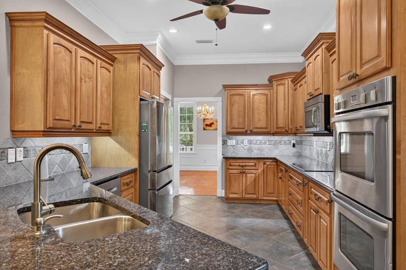Kitchen sink with granite counters and tile backsplash at 1735 Hagans Ridge Ct