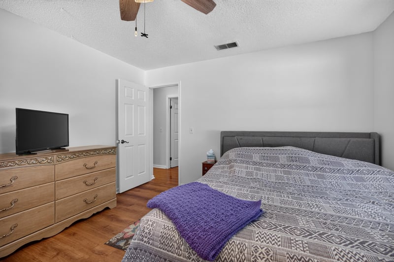 Bedroom with dresser and television at 2435 Range Line Rd, Middleburg, FL