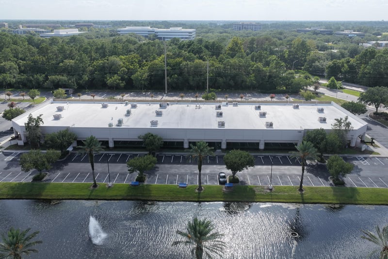 Aerial view of a roofline with pond and fountain at 10550 Deerwood Park Blvd, Jacksonville, FL 32256