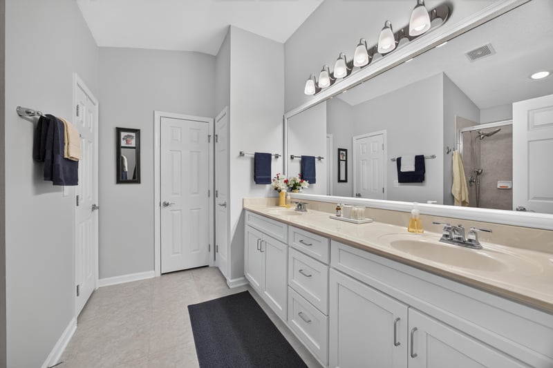 Primary bathroom vanity and mirror at 11225 Water Spring Cir, Jacksonville, FL 32256
