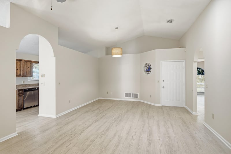 Living area with pendant light and arched opening at 678 5th Ave N, Jacksonville Beach, FL 32250