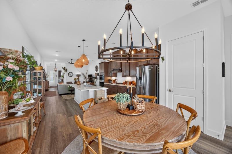 Dining area open to kitchen with chandelier at 129 Amberwood Dr, St. Augustine, FL