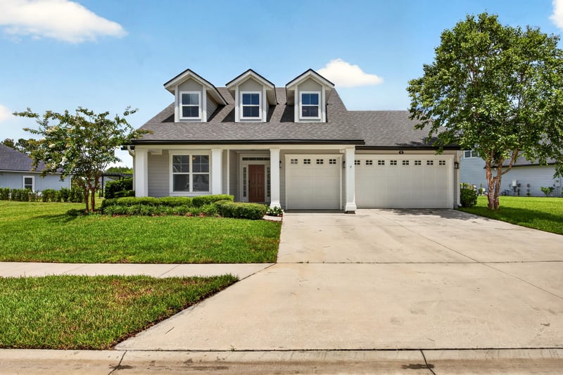 Front exterior view with dormers and landscaped entry at 53 Lumen Ct, St. Augustine, FL 32095