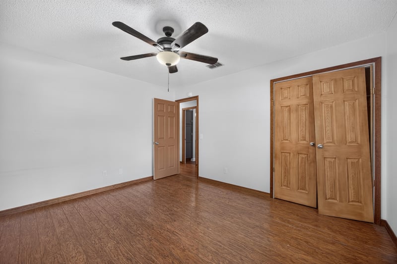Bedroom with double closet doors and wood floors at 892 Branscomb Rd, Green Cove Springs, FL