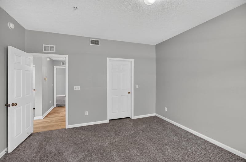 Hallway with multiple doors and carpet at 575 Oakleaf Plantation Pkwy, Orange Park, FL 32065